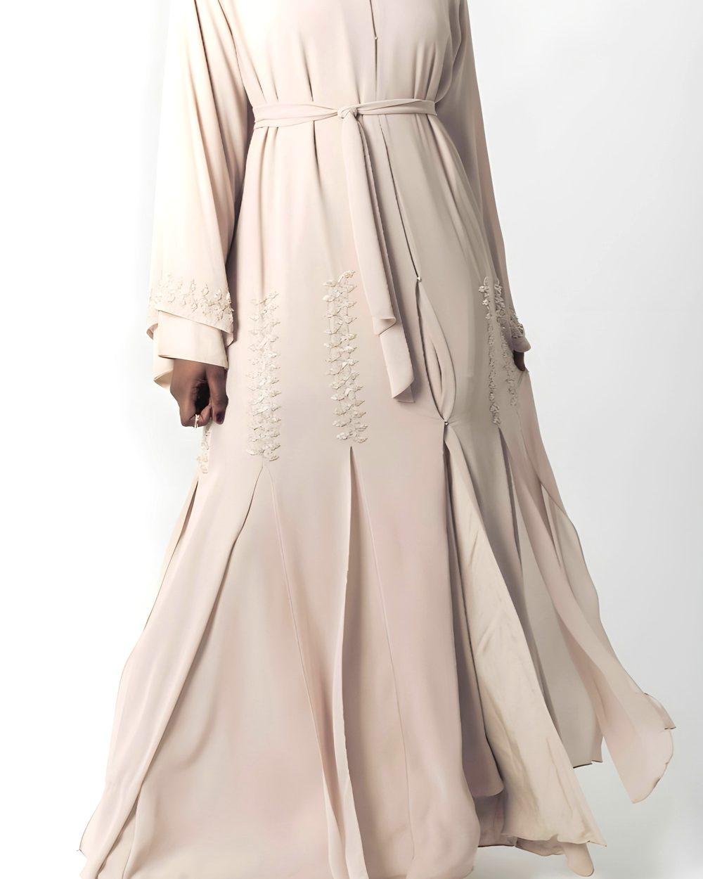 Woman in a long beige abaya