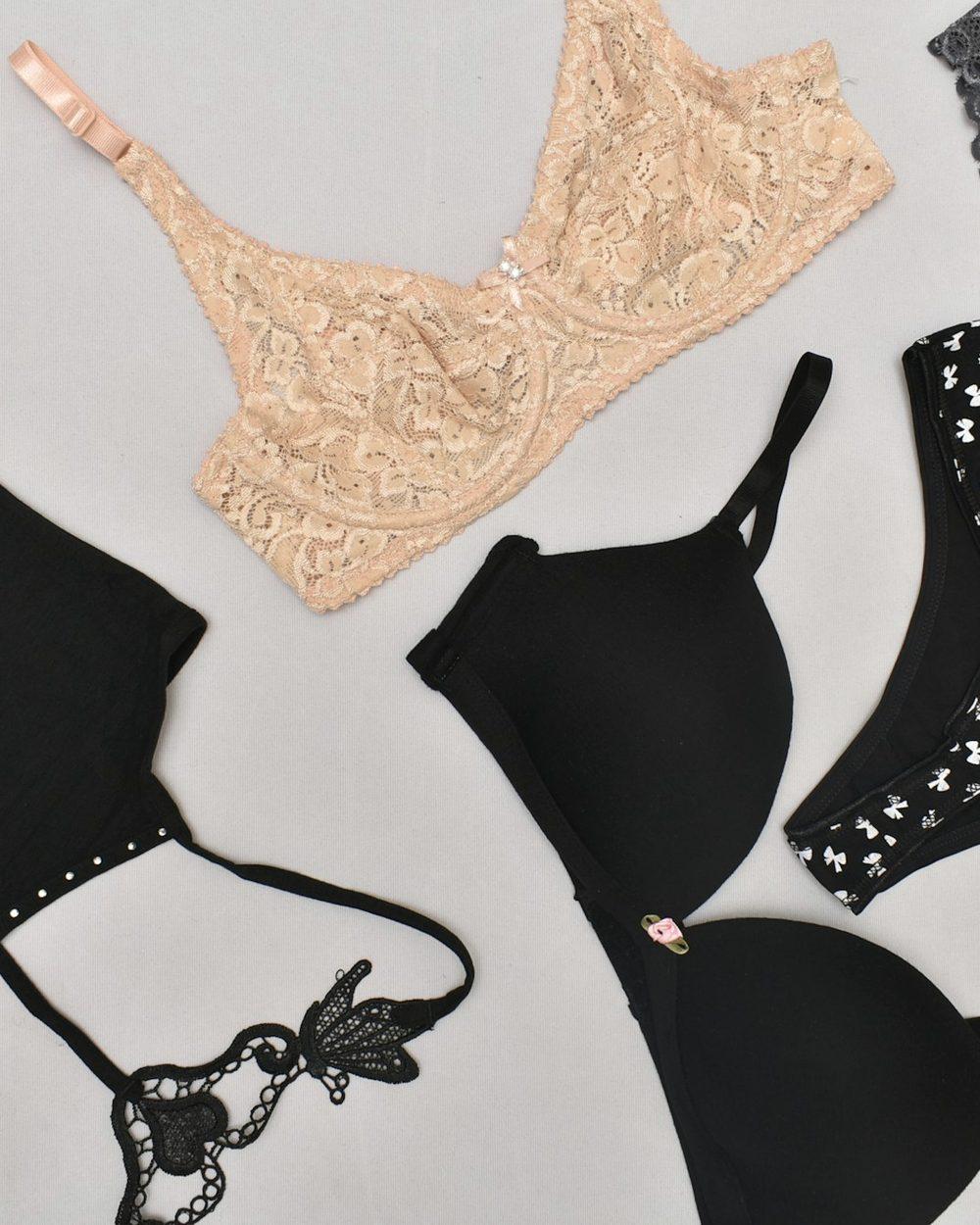 Bras and briefs laid out on a light surface