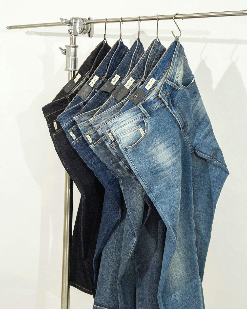 Blue jeans hanging on a clothing rack