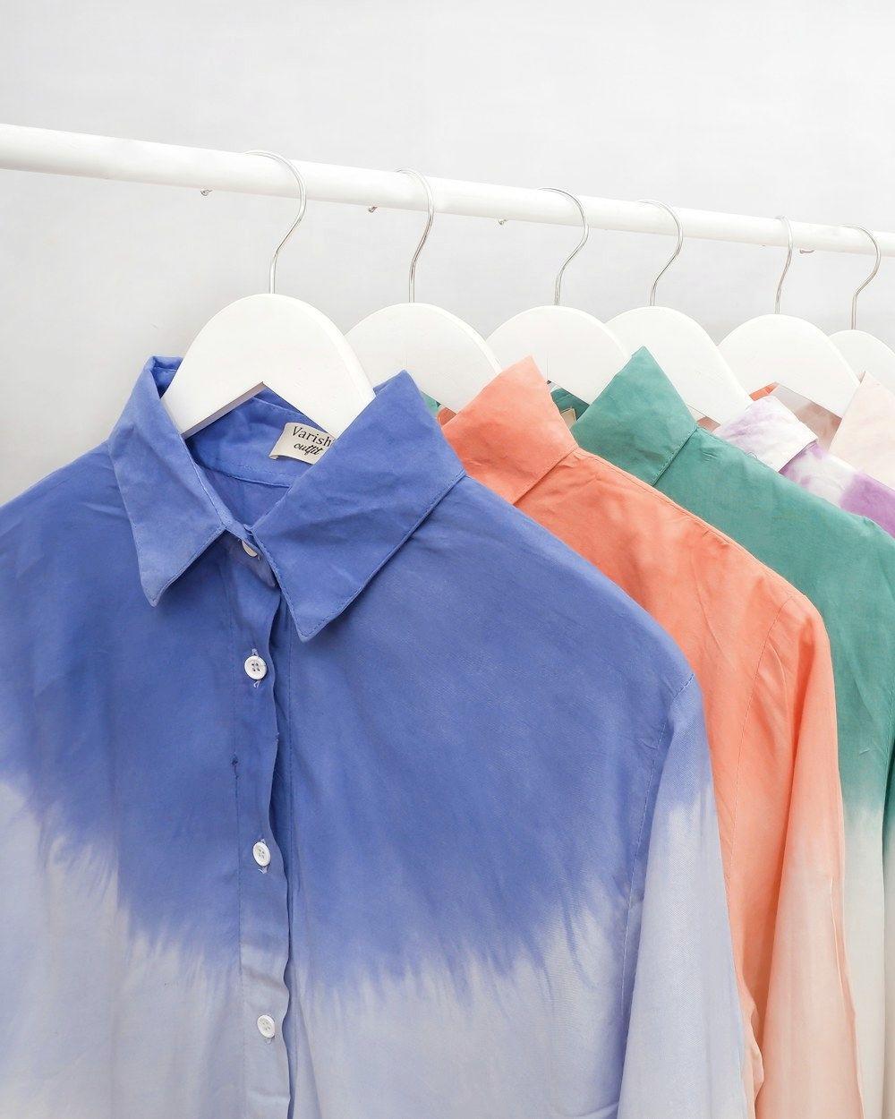 Dip-dyed button-up shirts on hangers